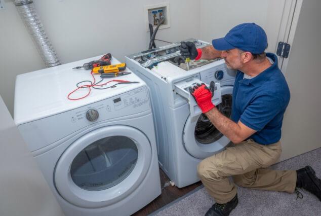 professional technician fixing a refrigerator in White Plains